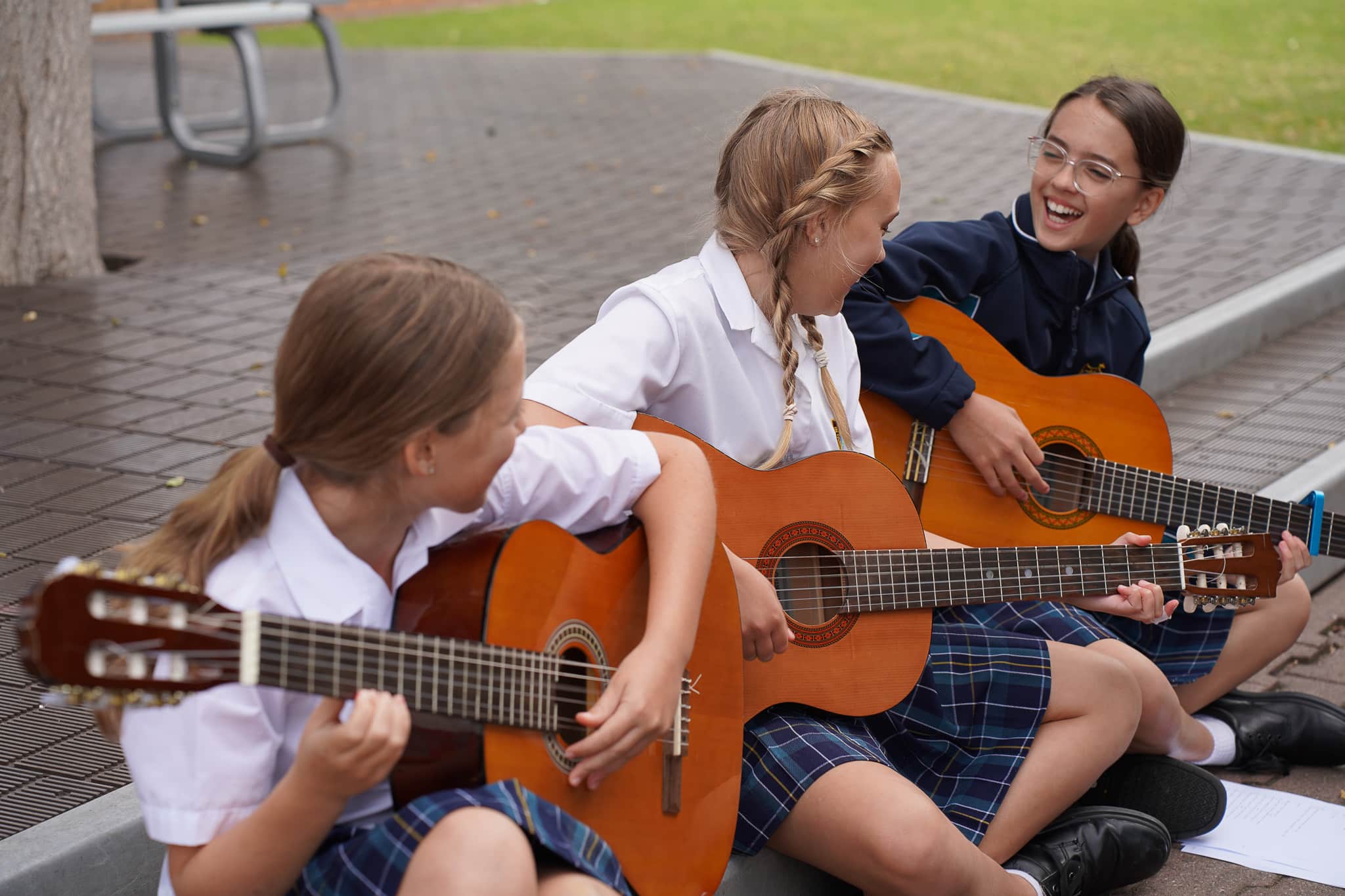 Students playing guitars together