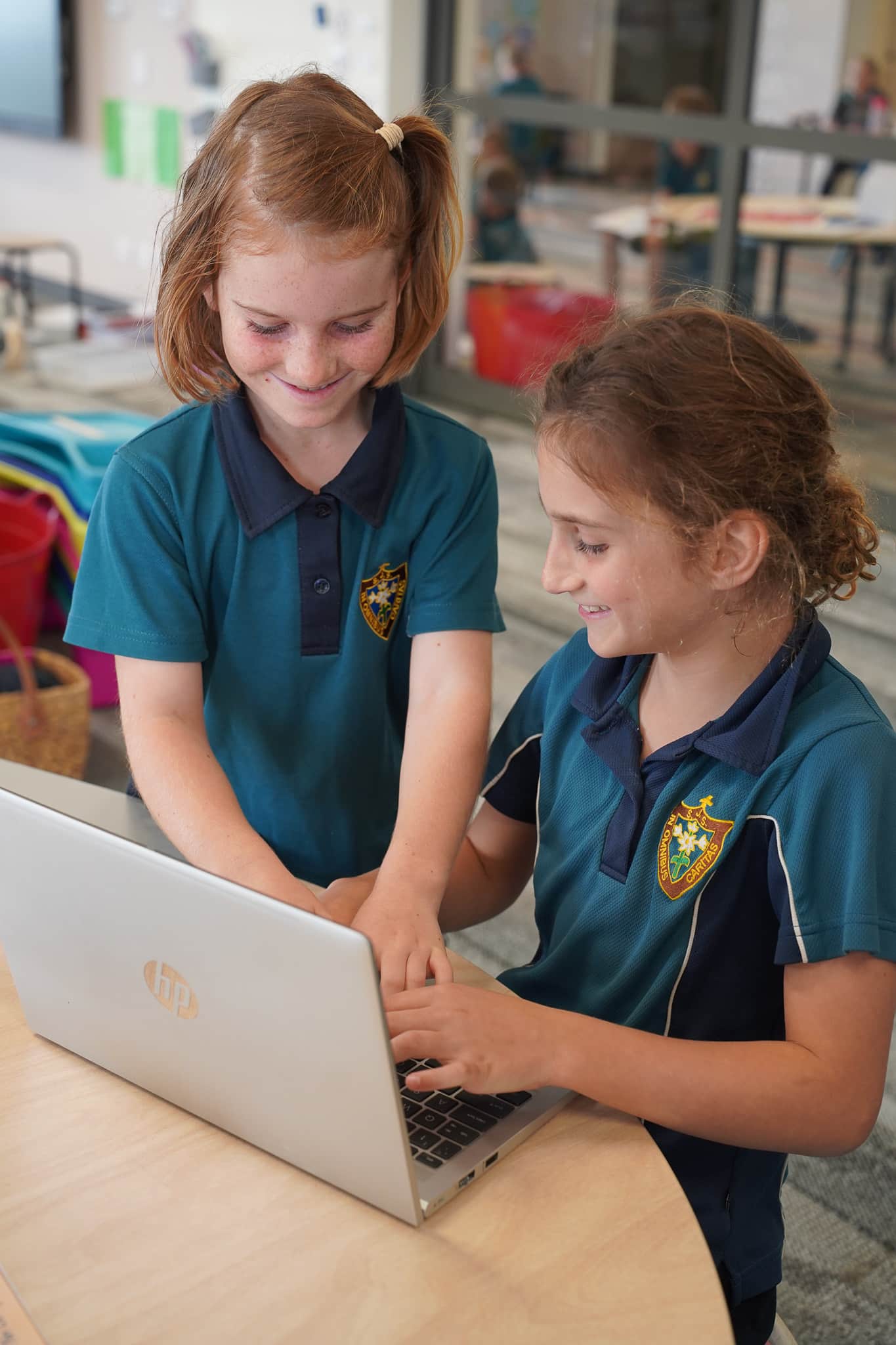 Primary students using a laptop for educational activities