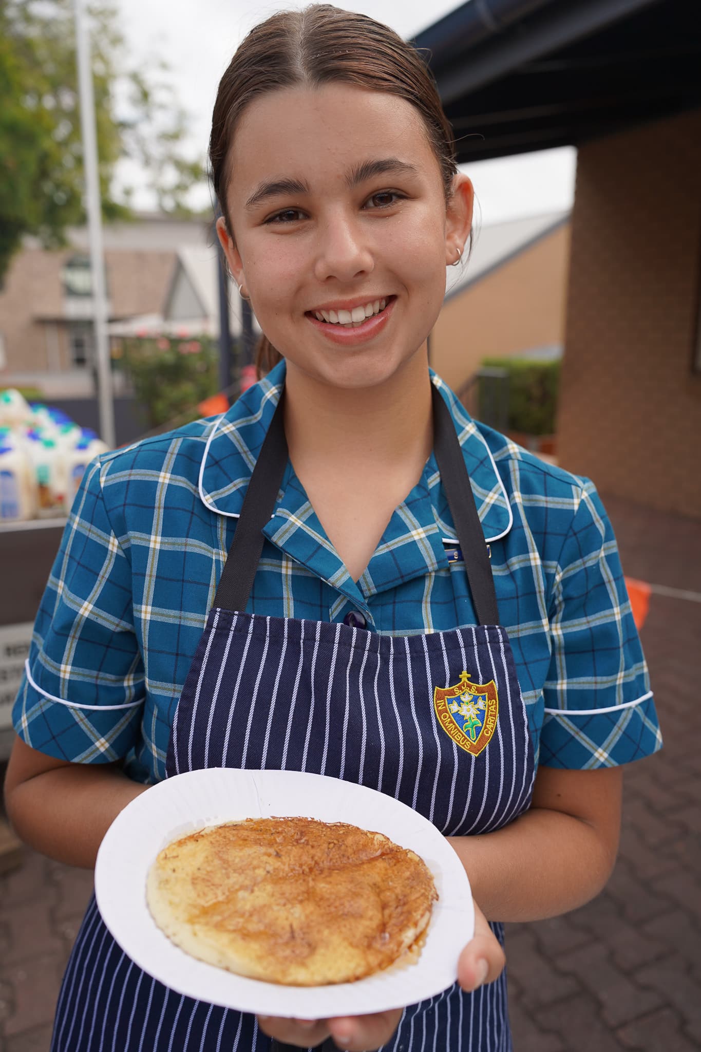 Student representative council - student serving pancake on Shrove Tuesday